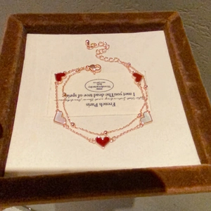 Double-layer mother of pearl heart bracelet in rose gold finish on jewelry box display