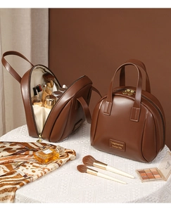 Macro detail of large brown PU leather shell makeup bag with open view showing ample storage