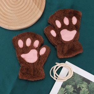 Detail of brown plush cat paw fingerless gloves with pink 3D paw pads on green fabric