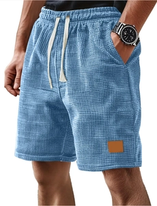 Detail of blue waffle knit fabric on men's casual shorts with drawstring waist