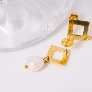 Elegant gold square geometric earrings with natural baroque pearls on a white background