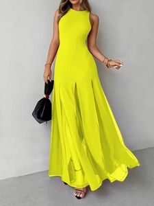 Detail of neon yellow sleeveless maxi dress featuring a pleated skirt and split hemline
