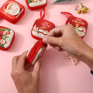 Macro shot of a Christmas tinplate coin purse featuring a festive Santa Claus and snowman design