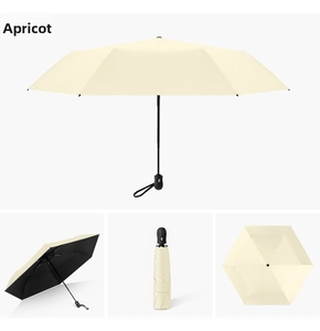 Detail of apricot folding umbrella with black UV coating and ergonomic handle strap
