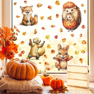 Fall window clings set with fox, hedgehog, and maple leaves on a bright glass window