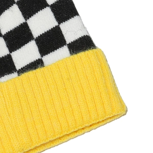Close-up of black and white checkerboard knit pattern with bright yellow ribbed edge details