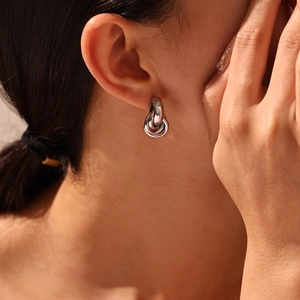 Modern intertwined multi-hoop earrings in polished silver finish for a minimalist style