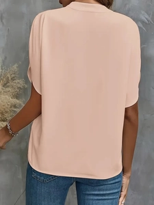 Detail view of pink chiffon blouse back showing loose fit and lightweight fabric texture