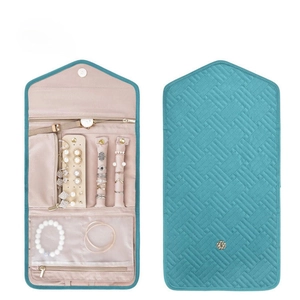 Internal compartments of the foldable quilted jewelry travel organizer in teal and beige
