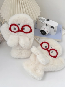 Close-up of white plush mittens featuring cartoon red-framed glasses and soft fur texture