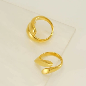 Detail view of 18k gold plated stainless steel teardrop rings with mirror polished finish