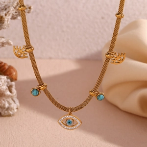 Close-up of gold evil eye necklace with turquoise beads and delicate diamond accents