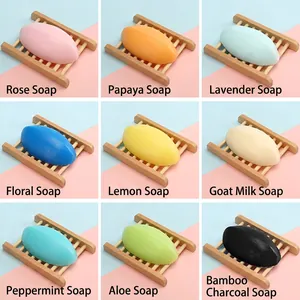 Set of 9 handmade essential oil soaps with floral and fruit scents on wooden holders