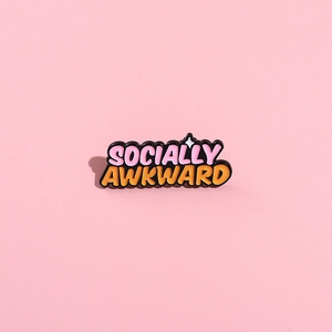 Socially Awkward enamel pin with pink and orange colors and black metal plating