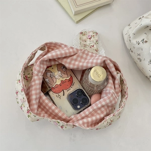 Top view of floral canvas tote showing interior capacity with phone and perfume