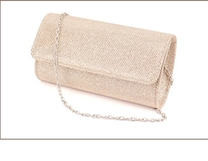 Detail of glitter champagne gold evening clutch bag with a sleek silver metal chain