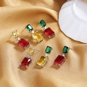 Elegant rectangle cut colorful gemstone drop earrings displayed on golden silk fabric