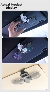 Close-up of car sun visor glasses clips in black and white in a vehicle interior