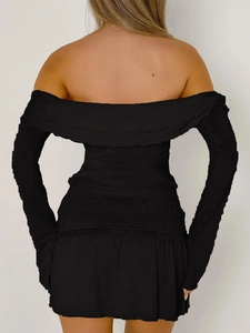 Detailed back view of a black Y2K style off-shoulder long sleeve top on a model