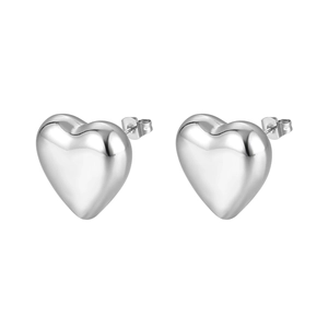 Macro shot of polished heart-shaped silver earrings with secure butterfly backings