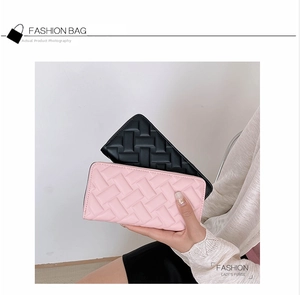 Close-up of quilted long leather wallet for women with high-quality zipper and woven texture