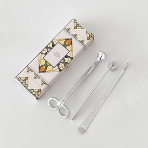 Silver stainless steel candle care set with wick trimmer and snuffer in a pink gift box