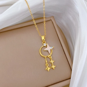 Elegant gold titanium steel necklace with star and moon pendant on a soft beige background