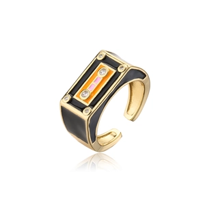 Detailed side view of a vintage gold cassette tape ring with colorful enamel and zircon