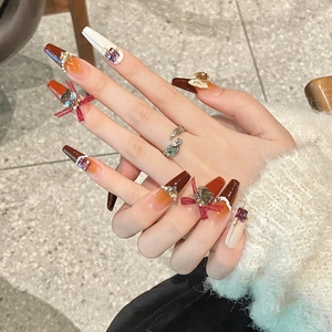 Faux ongles faits main dégradé ambre avec nœuds en velours 3D et strass brillants