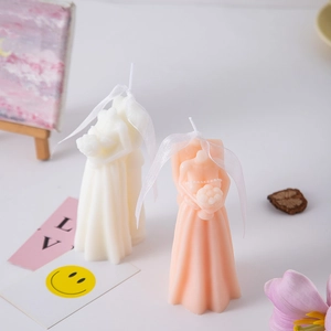 Creative wedding dress scented candles in cream and pink colors with silk ribbon