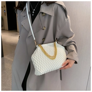 Detail of white quilted handbag with golden chain strap and leather cross-body option