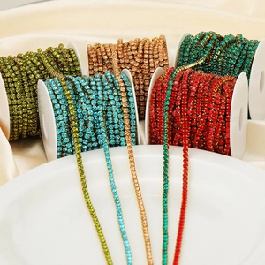 Macro detail of colorful crystal rhinestone claw chain on spools for DIY fashion crafts
