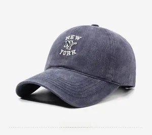 Detail view of New York NY embroidery on washed denim baseball cap with retro style
