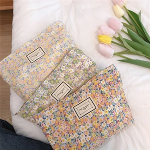 Detailed view of floral canvas storage bags with zipper and TIME TO PARTY label