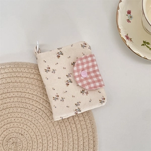 Close-up of floral fabric card holder with pink plaid flap and sweet snap button detail