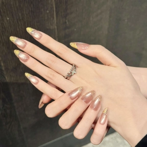 Hand-made almond press-on nails in nude pink pearl with gold glitter gradient tips