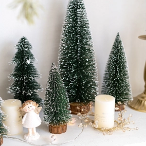 Mini green flocked Christmas trees with white candles and angel figurine tabletop decor
