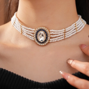 Detail of five-row pearl necklace with gold oval pendant and deep blue enamel inlay