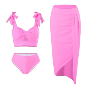 Detailed view of pink three-piece bikini set with high-waist bottom and matching sarong skirt