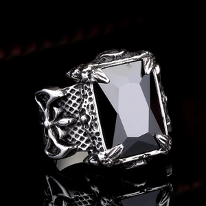 Macro view of vintage steel ring featuring black gemstone and engraved cross patterns