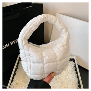 Detail of white quilted cloud handbag with plush padding and durable zipper closure