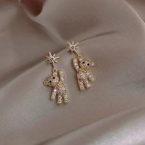 Elegant gold drop earrings with bear and star motifs encrusted with white crystals