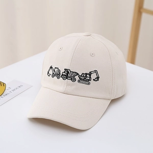 Close-up of beige cotton baseball cap with embroidered excavators and dump trucks for boys