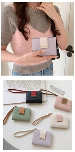 Detail of elegant floral embossed wallets in various colors with a stylish wrist strap