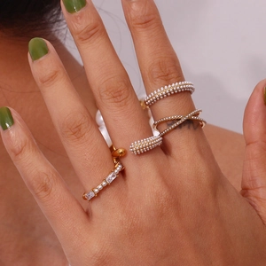 Detail shot of gold-plated stacked rings with micro pearls and rectangular zircons