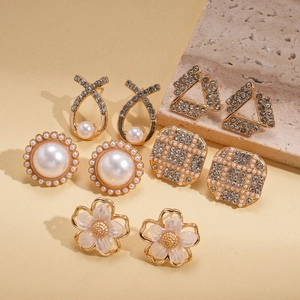 Set of 5 gold pearl and rhinestone earrings featuring floral and geometric patterns