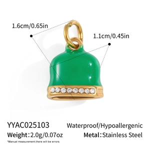 Macro detail of a 18K gold plated stainless steel bell pendant with green enamel and zircons