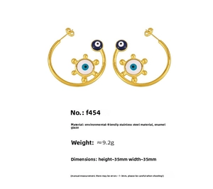 Detailed view of 18K gold plated stainless steel evil eye hoop earrings with enamel inlay