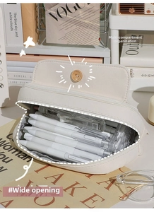 Detail of high-capacity canvas pencil case with button closure and spacious interior storage