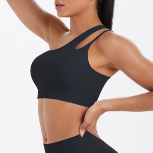 Detail of black one-shoulder sports bra featuring cut-out design and matte elastic fabric